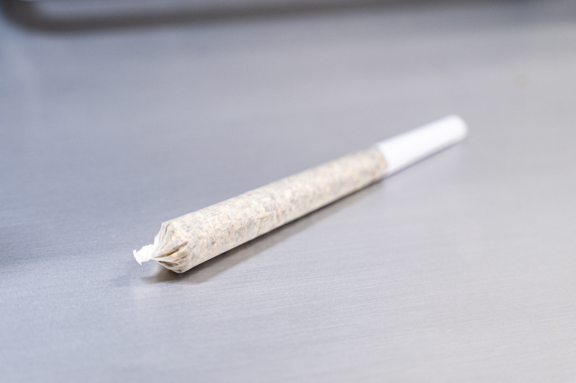 A pre-rolled joint made with the AutoTwist Pre Roll Finishing machine, featuring a tightly packed and twisted cone-shaped joint with a filter tip at the end
